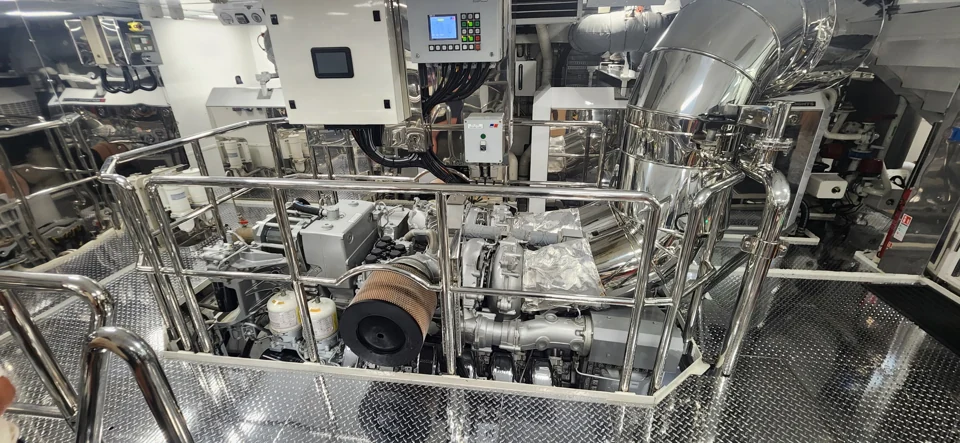 Yacht engine-room machinery with polished metal pipework and service walkways