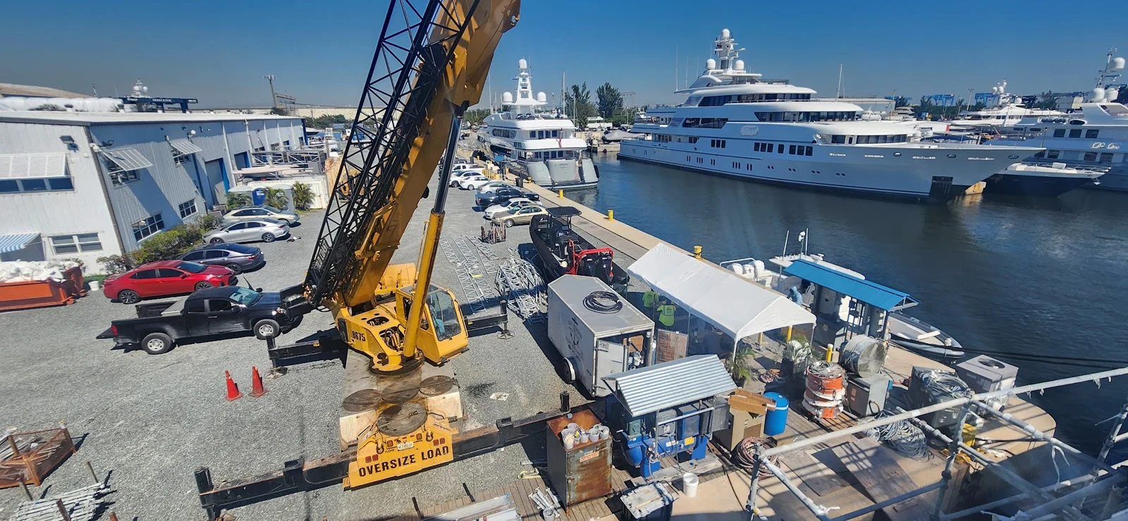 Crane positioned beside the dock for yacht equipment handling