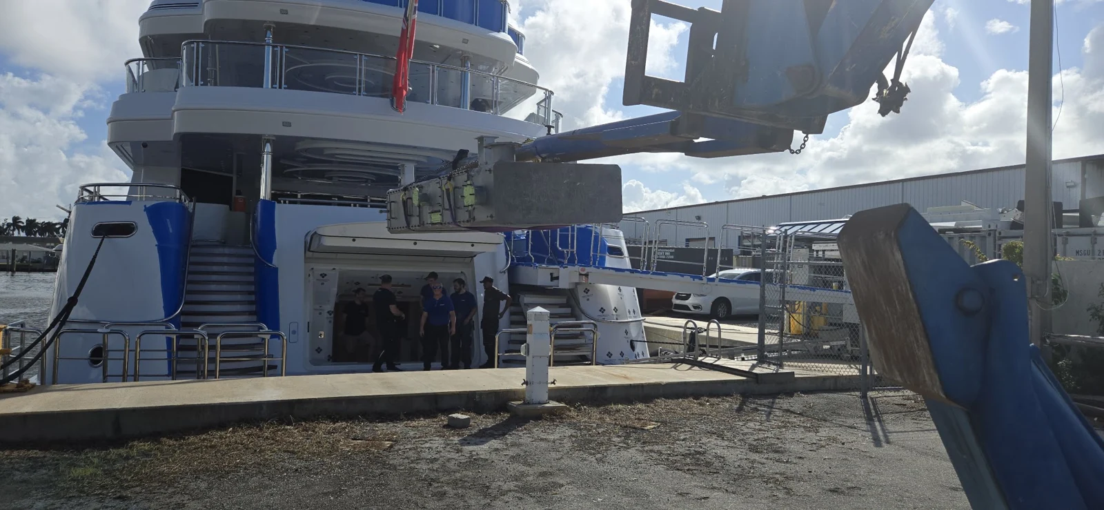 Dockside equipment handling beside a yacht