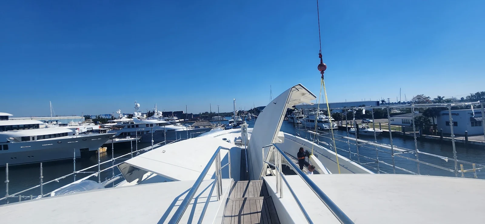 Crane lifting yacht equipment above the aft deck