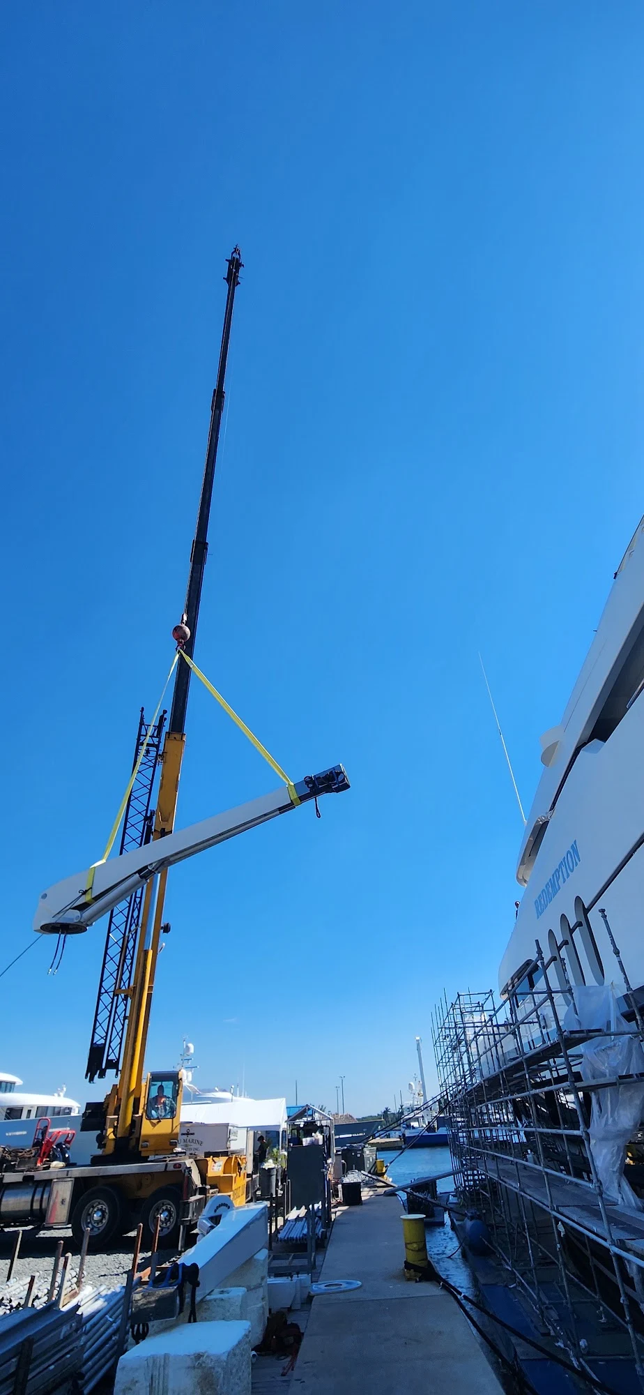 Crane lifting a yacht crane for repair